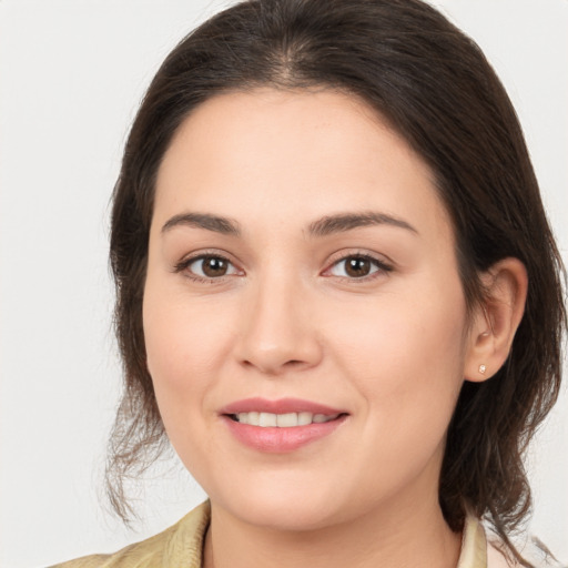 Joyful white young-adult female with medium  brown hair and brown eyes