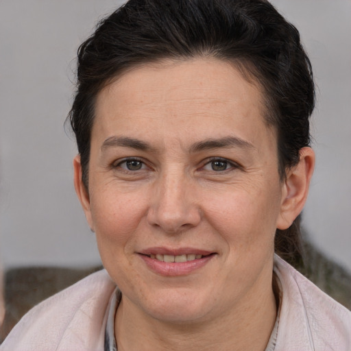 Joyful white adult female with short  brown hair and brown eyes