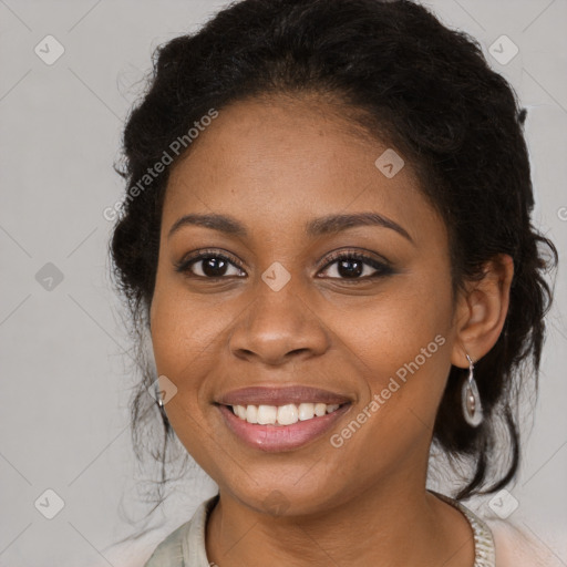 Joyful black young-adult female with long  brown hair and brown eyes