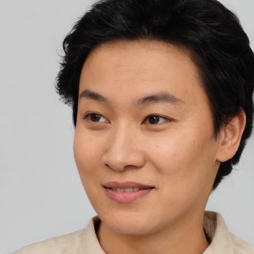 Joyful asian young-adult female with short  brown hair and brown eyes