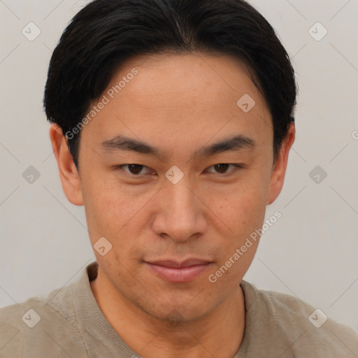 Joyful asian young-adult male with short  brown hair and brown eyes