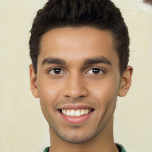 Joyful latino young-adult male with short  brown hair and brown eyes