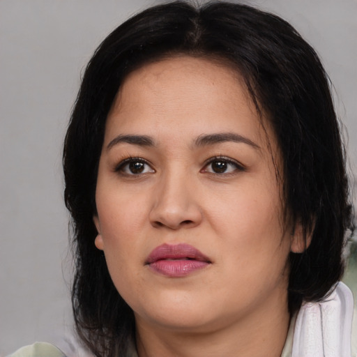 Joyful white young-adult female with medium  black hair and brown eyes