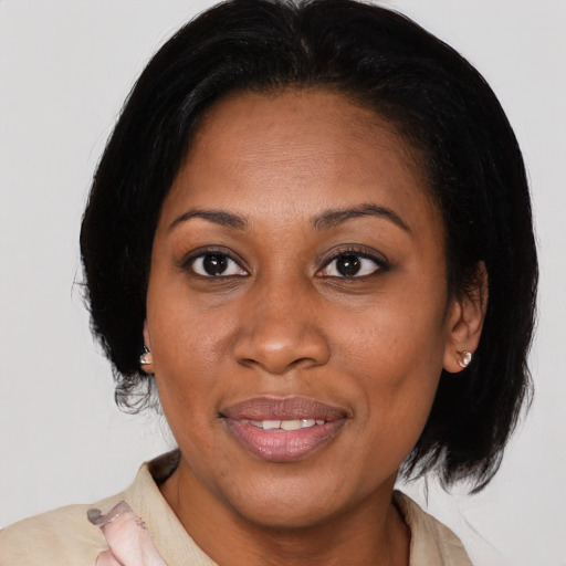 Joyful latino adult female with medium  brown hair and brown eyes