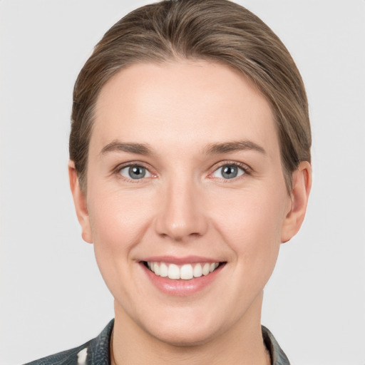 Joyful white young-adult female with short  brown hair and grey eyes