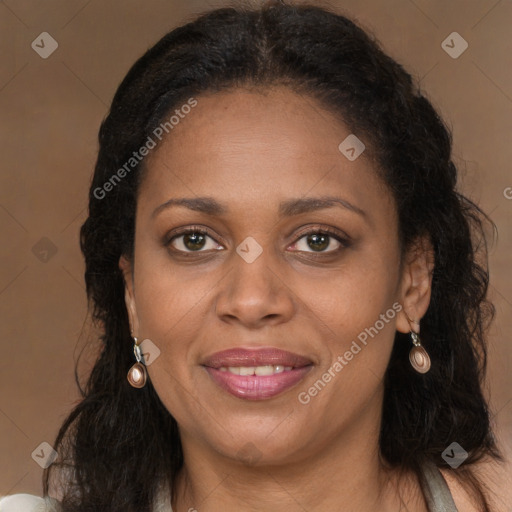Joyful black adult female with long  brown hair and brown eyes