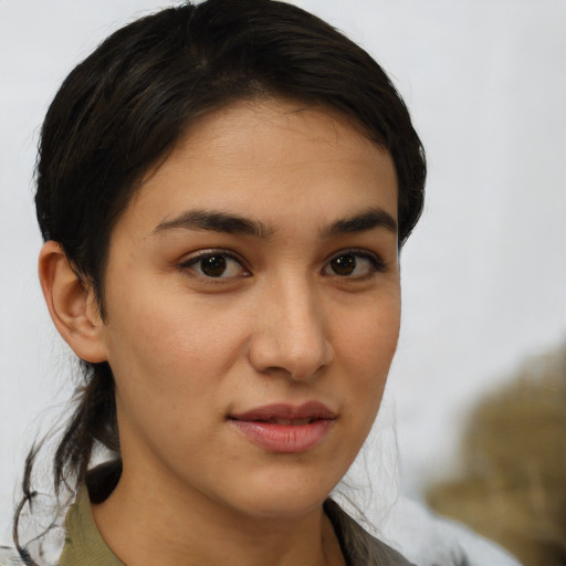 Joyful latino young-adult female with medium  brown hair and brown eyes