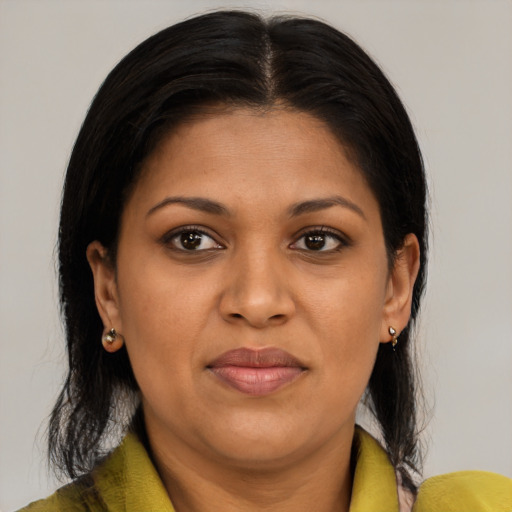 Joyful black adult female with medium  brown hair and brown eyes