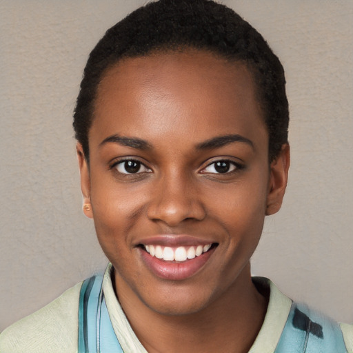 Joyful black young-adult female with short  black hair and brown eyes