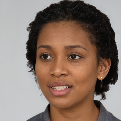 Joyful black young-adult female with medium  black hair and brown eyes