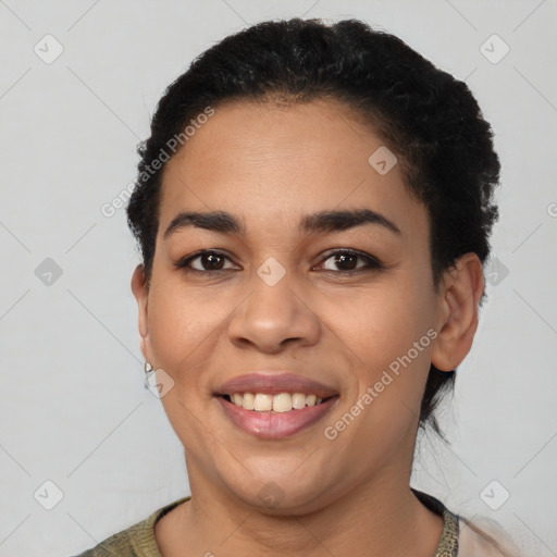 Joyful latino young-adult female with short  black hair and brown eyes