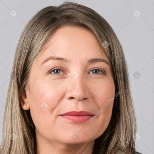 Joyful white adult female with long  brown hair and grey eyes