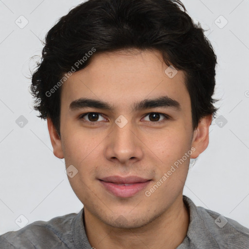 Joyful latino young-adult male with short  brown hair and brown eyes