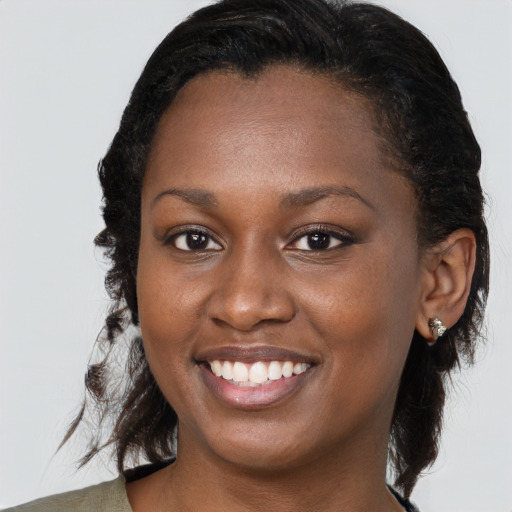 Joyful black young-adult female with medium  brown hair and brown eyes