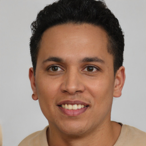 Joyful latino young-adult male with short  black hair and brown eyes