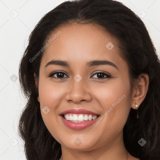 Joyful latino young-adult female with long  brown hair and brown eyes