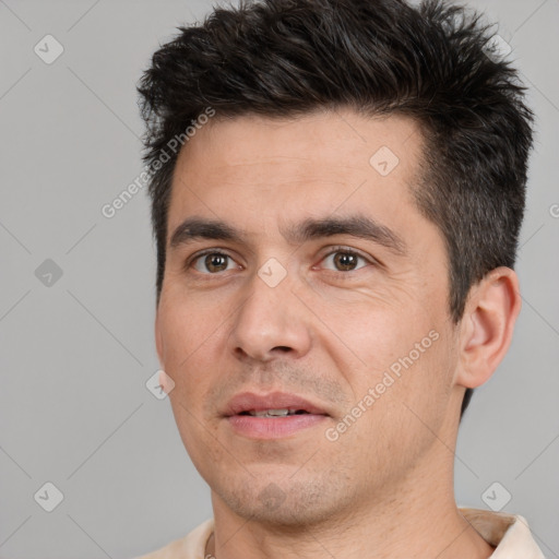 Joyful white adult male with short  brown hair and brown eyes