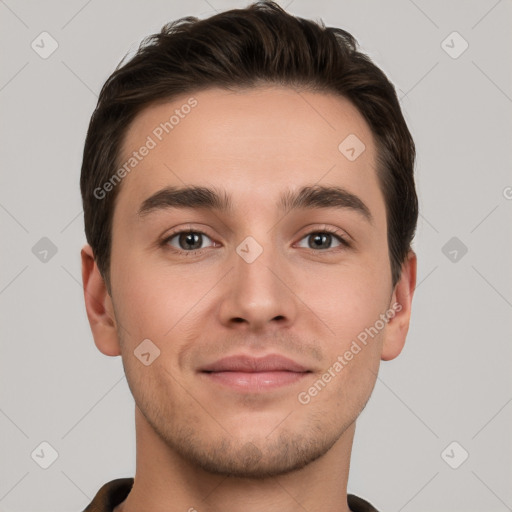 Joyful white young-adult male with short  brown hair and grey eyes