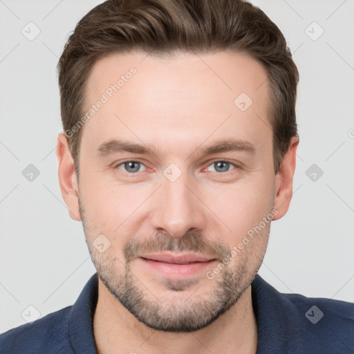 Joyful white young-adult male with short  brown hair and grey eyes