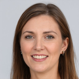 Joyful white young-adult female with long  brown hair and grey eyes