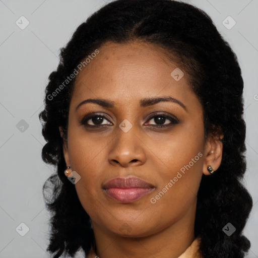 Joyful black young-adult female with long  brown hair and brown eyes