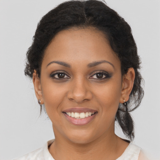 Joyful black young-adult female with medium  brown hair and brown eyes