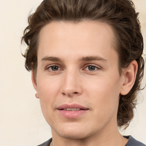 Joyful white young-adult male with medium  brown hair and brown eyes