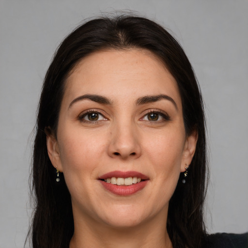 Joyful white young-adult female with long  brown hair and brown eyes