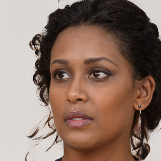 Neutral black young-adult female with long  brown hair and brown eyes