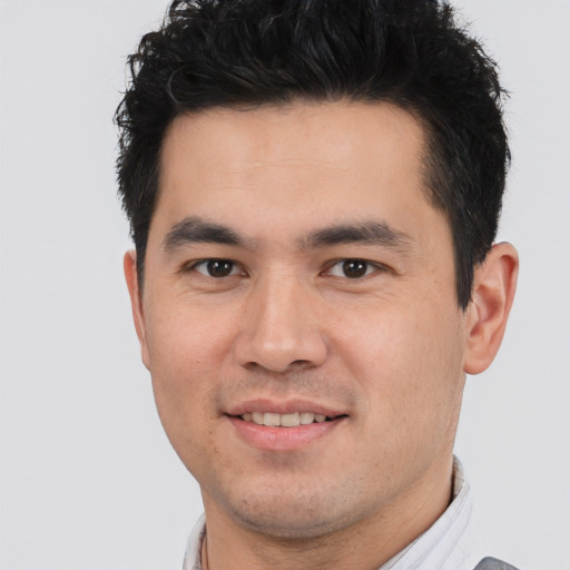 Joyful white young-adult male with short  black hair and brown eyes