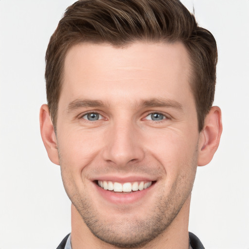 Joyful white young-adult male with short  brown hair and grey eyes