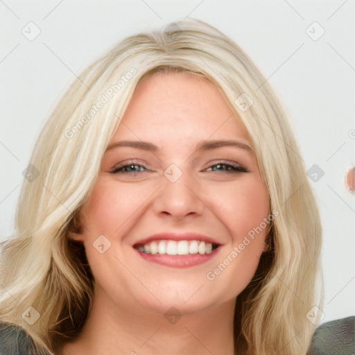 Joyful white young-adult female with long  brown hair and blue eyes