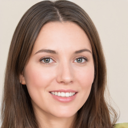 Joyful white young-adult female with long  brown hair and brown eyes