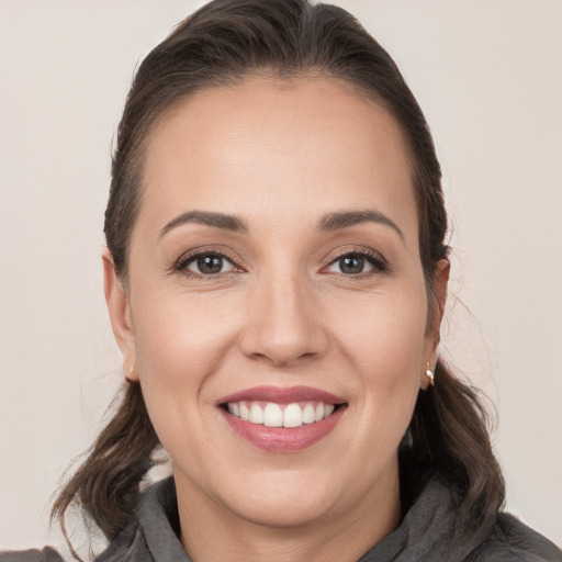 Joyful white young-adult female with medium  brown hair and brown eyes