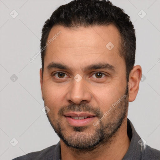 Joyful white young-adult male with short  black hair and brown eyes