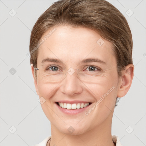 Joyful white young-adult female with short  brown hair and grey eyes