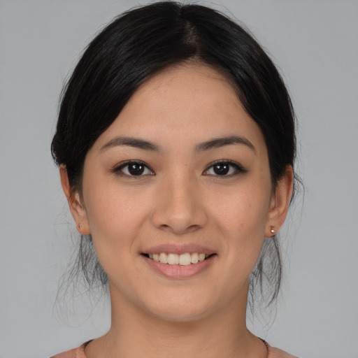 Joyful asian young-adult female with medium  brown hair and brown eyes
