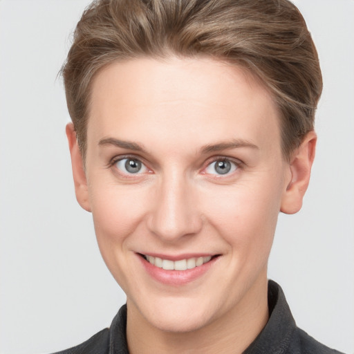 Joyful white young-adult female with short  brown hair and grey eyes