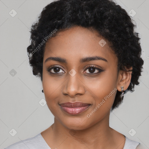 Joyful black young-adult female with short  black hair and brown eyes