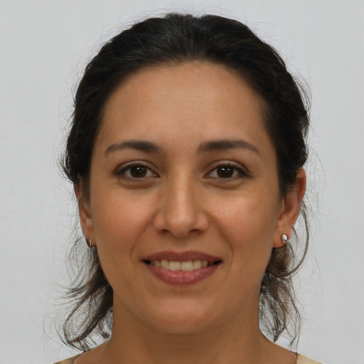Joyful latino young-adult female with medium  brown hair and brown eyes