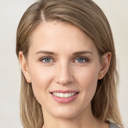 Joyful white young-adult female with long  brown hair and grey eyes