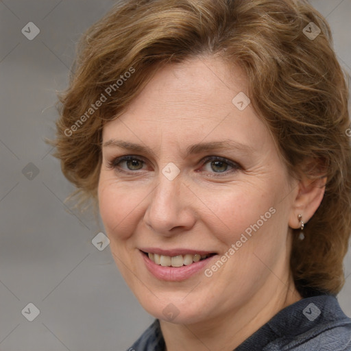 Joyful white adult female with medium  brown hair and blue eyes