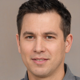 Joyful white adult male with short  brown hair and brown eyes