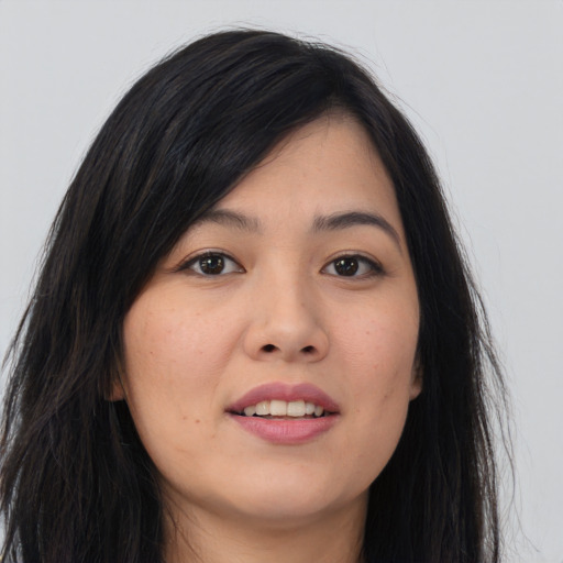 Joyful asian young-adult female with long  brown hair and brown eyes