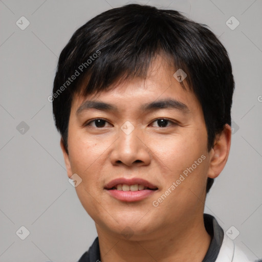 Joyful asian young-adult male with short  black hair and brown eyes