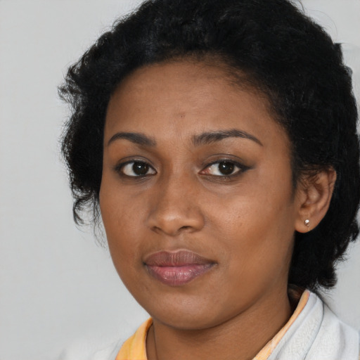 Joyful black young-adult female with short  brown hair and brown eyes