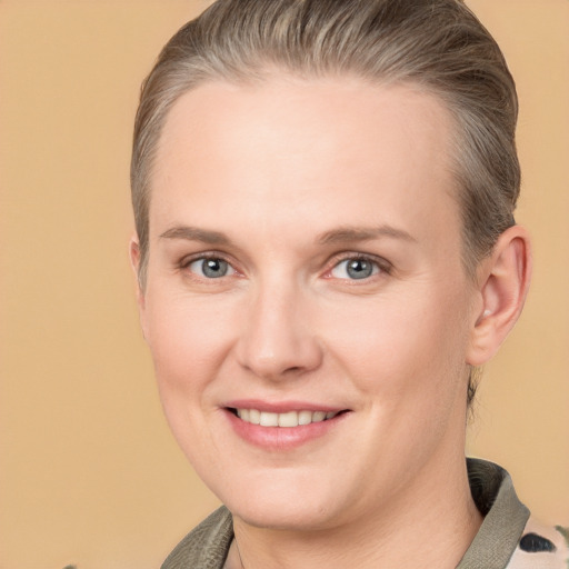 Joyful white adult female with short  brown hair and grey eyes