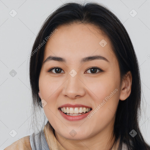 Joyful asian young-adult female with long  brown hair and brown eyes