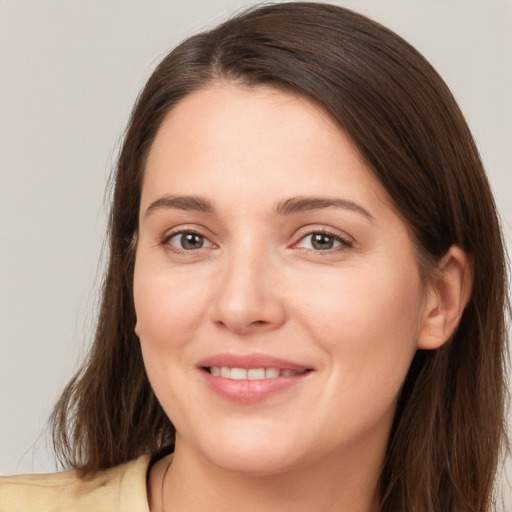 Joyful white young-adult female with long  brown hair and brown eyes