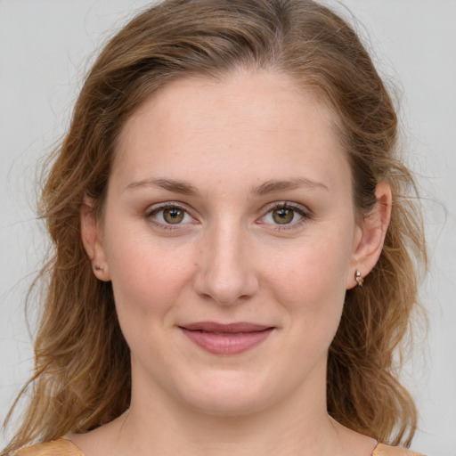 Joyful white young-adult female with medium  brown hair and green eyes